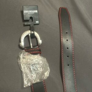 A black true religion belt with red trim, brand new size30